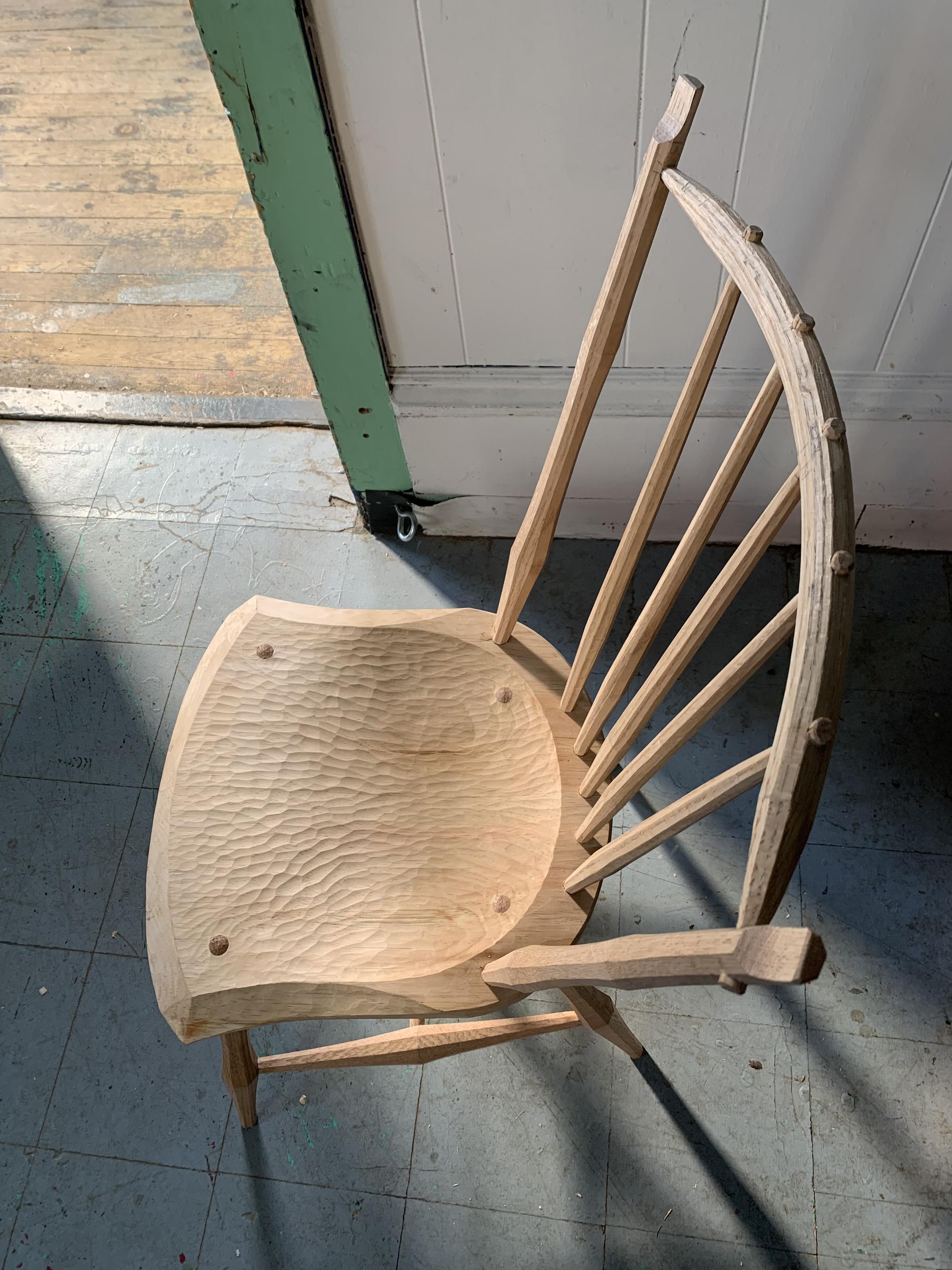 unpainted chair in dramatic light