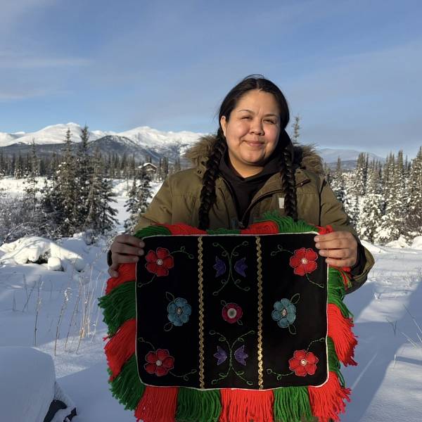 Kayleen Ward-Peter holding beadwork outdoors in the snow
